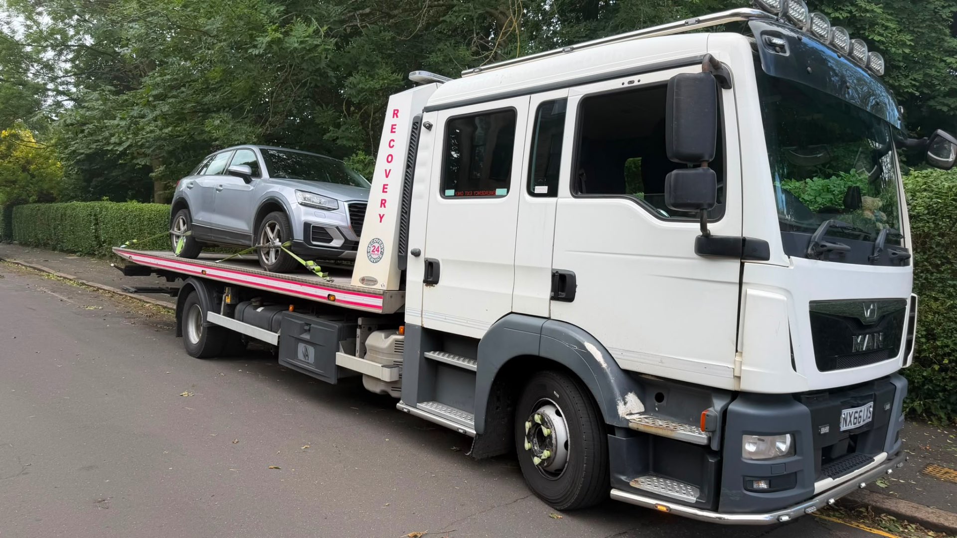 MAN 24-hour recovery truck with silver Audi Q2 on flatbed
